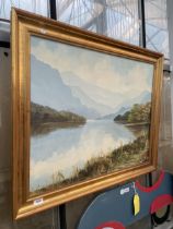 A GILT FRAMED OIL ON CANVAS OF A LAKE SCENE