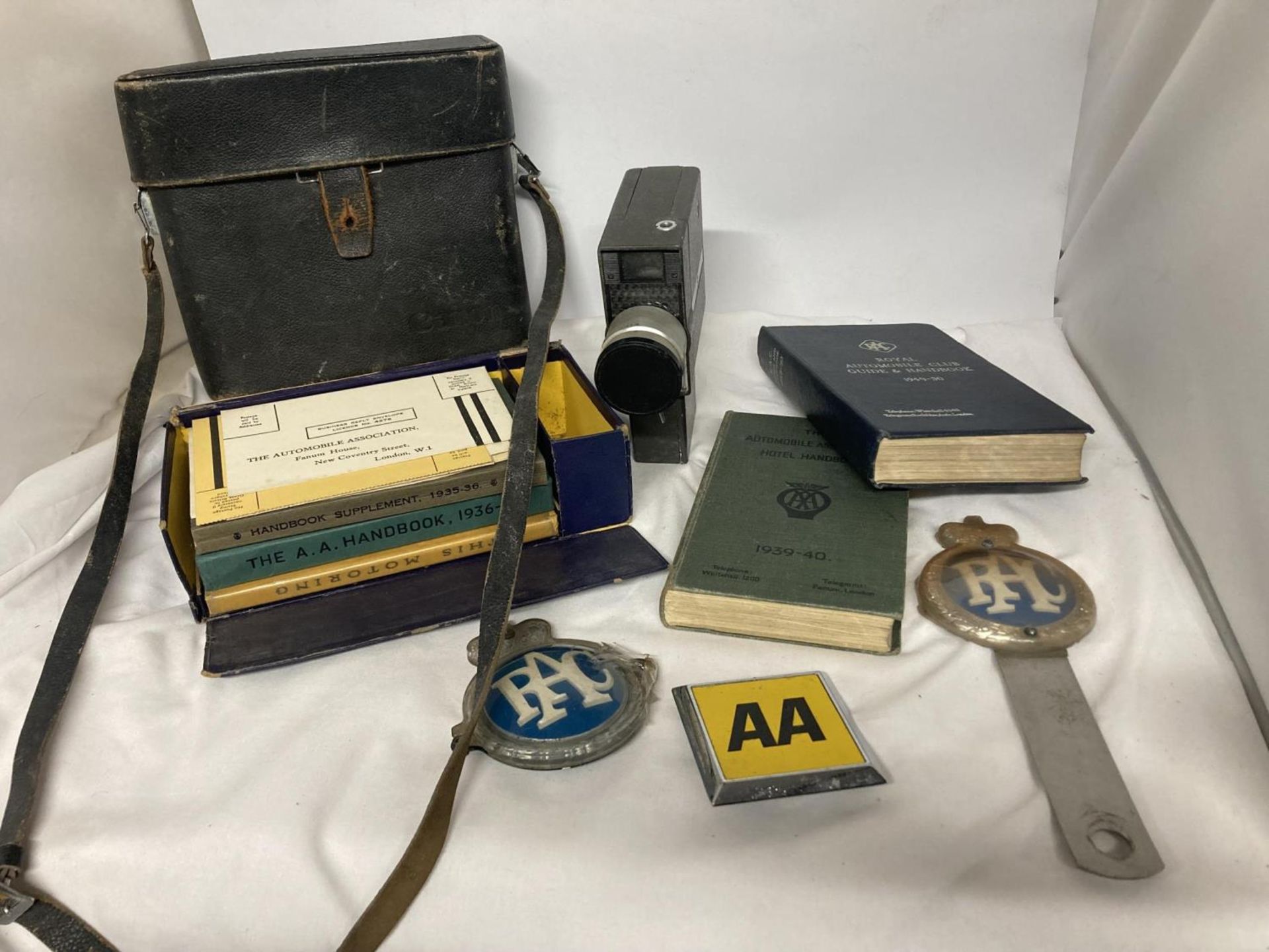 A SET OF PRE-WAR AND EARLY POST-WAR AA HANDBOOKS, PLUS TWO RAC AND ONE AA CAR BADGES PLUS TWO