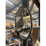 AN ORNATE BRASS FRAMED OVAL WALL MIRROR