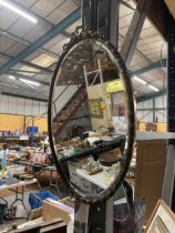 AN ORNATE BRASS FRAMED OVAL WALL MIRROR