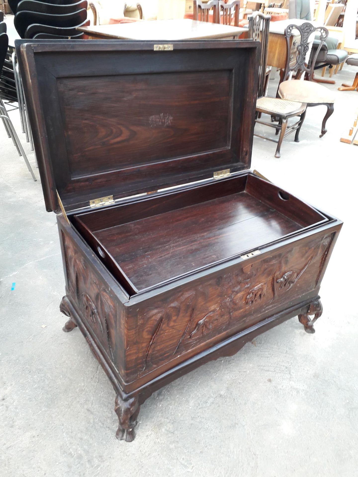 AN ORIENTAL HARDWOOD BLANKET CHEST PROFUSELY CARVED WITH ELEPHANTS AND TREES, COMPLETE WITH LIFT-OUT - Image 6 of 8