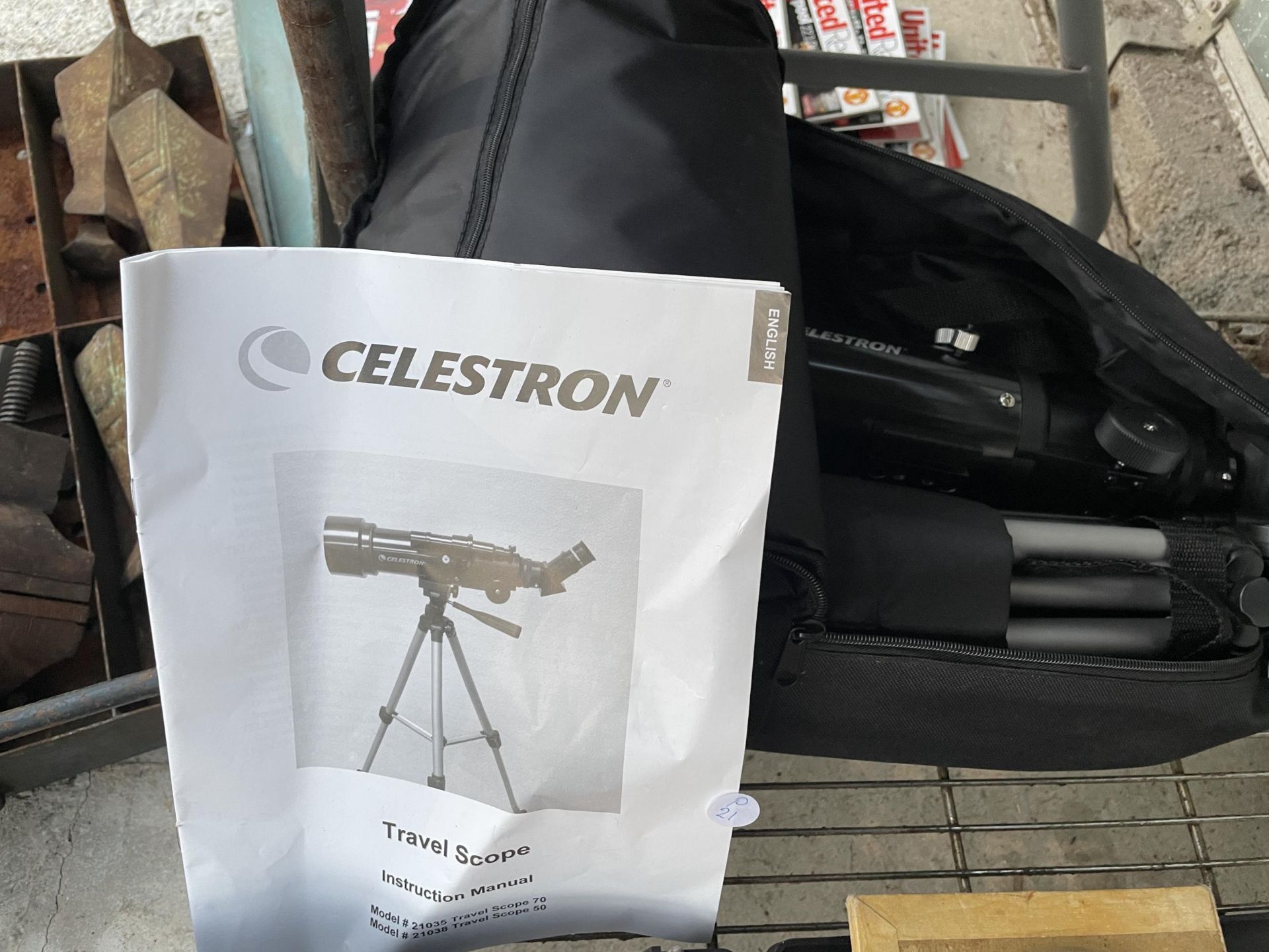 A CELESTRON TRAVEL TELESCOPE WITH CARRY BAG AND MANUAL