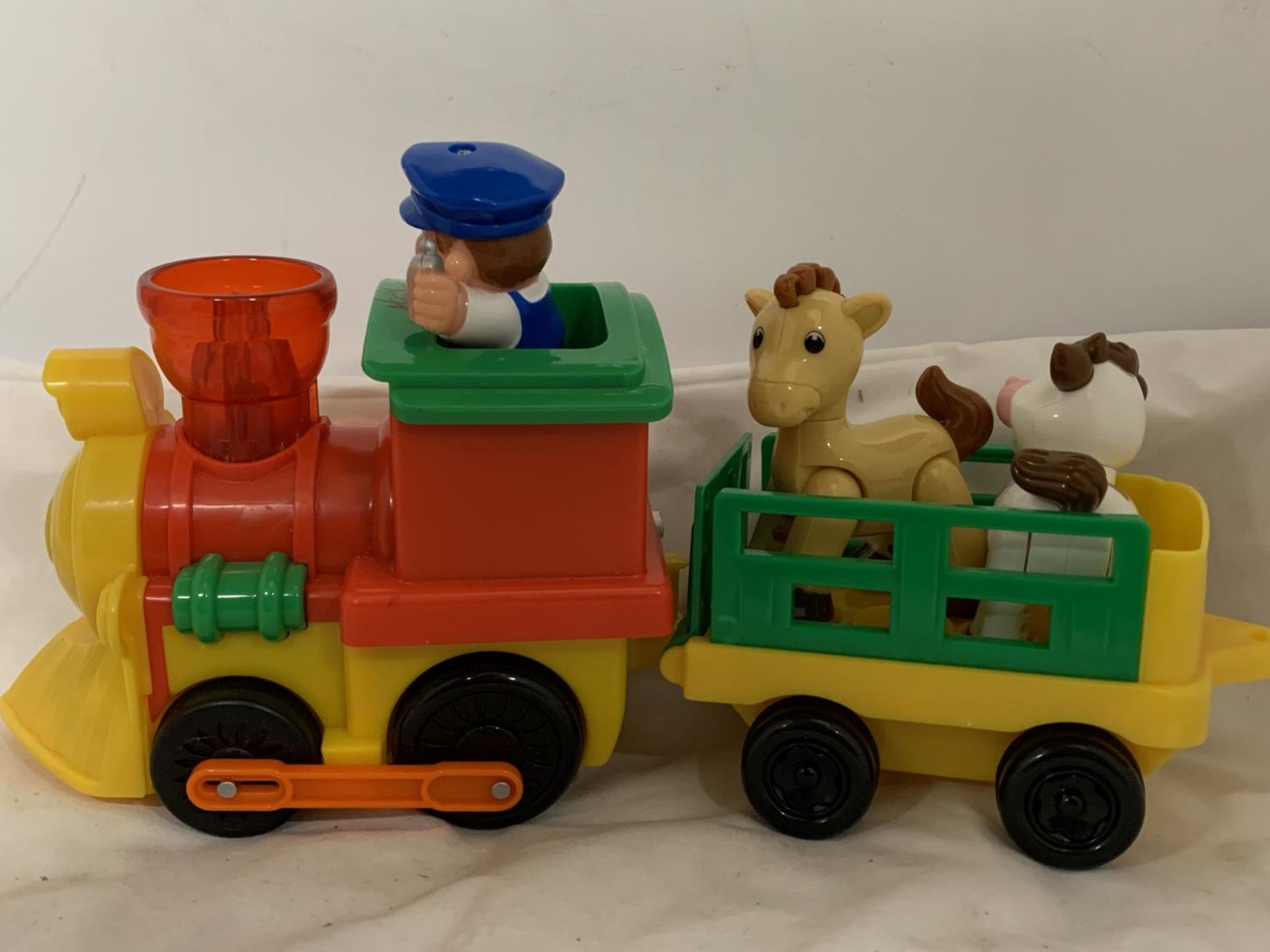 A HAMLEYS MUSICAL CHOO CHOO TRAIN AND TRACK WITH ANIMALS