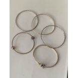 FIVE VARIOUS SILVER BANGLES TO INCLUDE A PANDORA AND A CHAMILIA