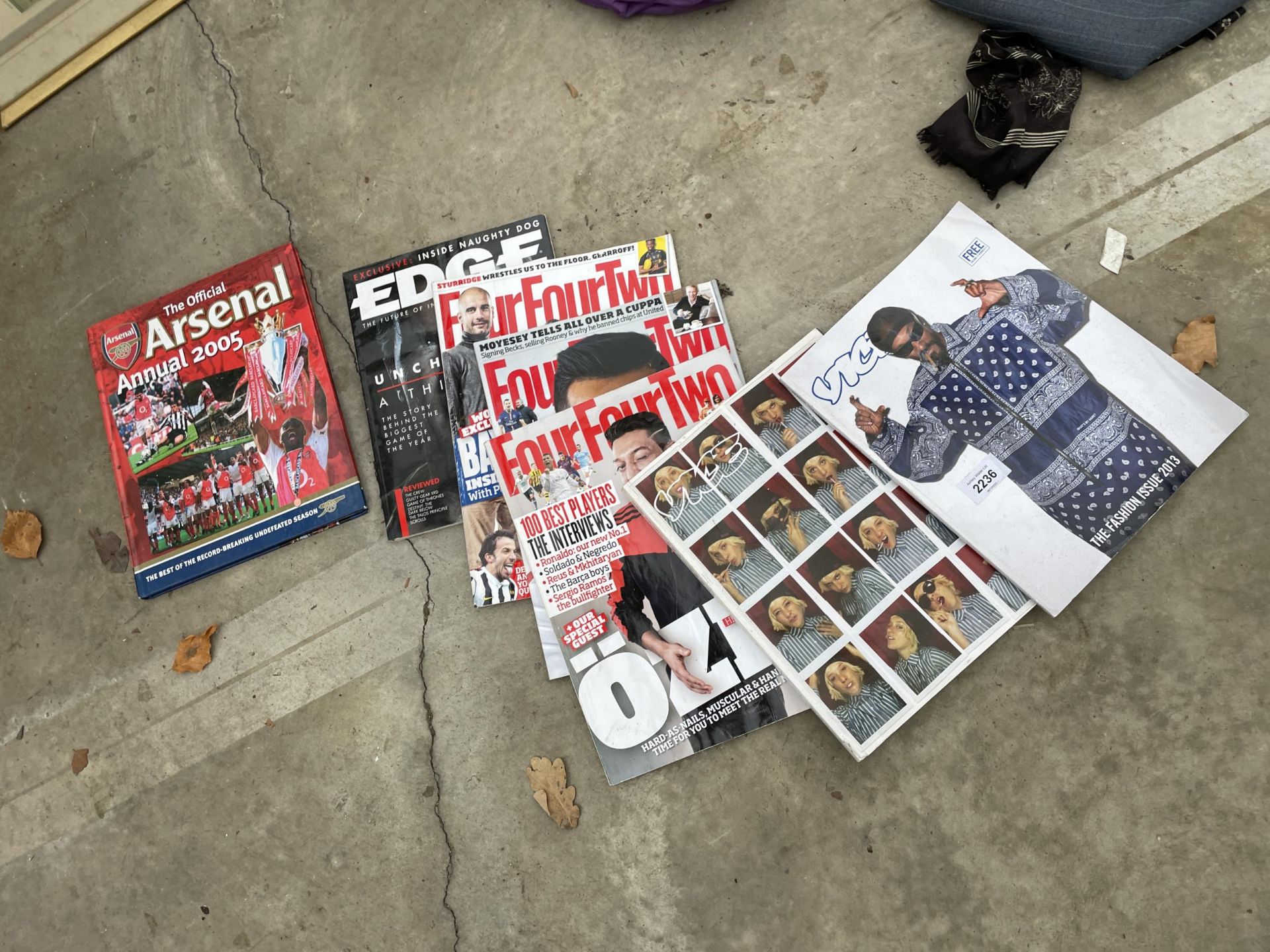 AN ASSORTMENT OF SPORTS MAGAZINES AND TENNIS RACKETS ETC