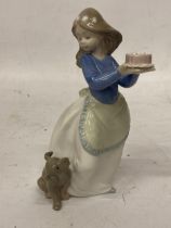 A NAO FIGURINE OF A GIRL WITH A BIRTHDAY CAKE AND PUPPY