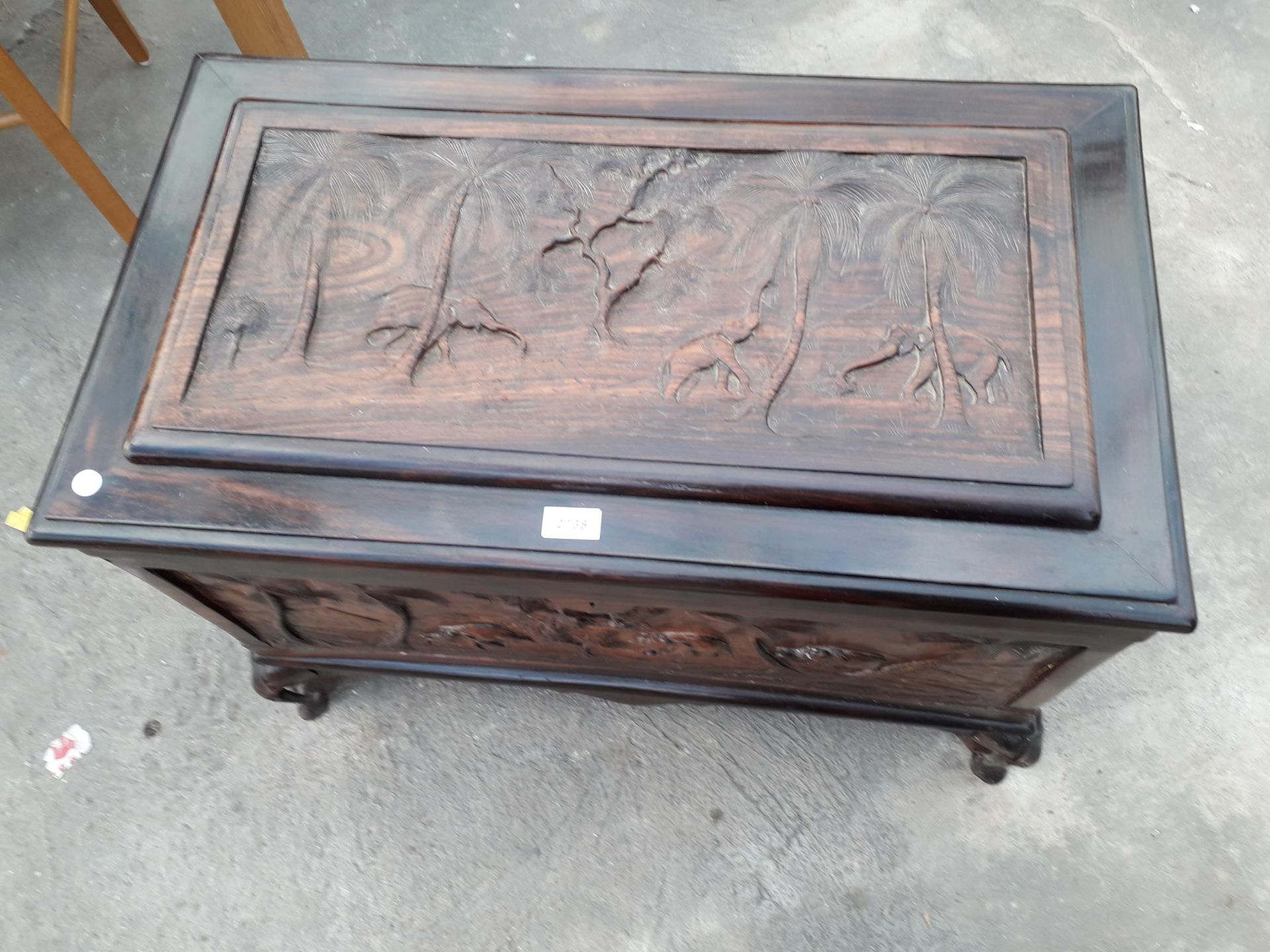 AN ORIENTAL HARDWOOD BLANKET CHEST PROFUSELY CARVED WITH ELEPHANTS AND TREES, COMPLETE WITH LIFT-OUT - Image 4 of 8