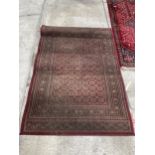 A RED PATTERNED 'TIARA' RUG