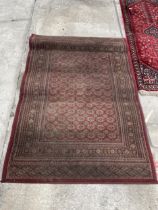 A RED PATTERNED 'TIARA' RUG