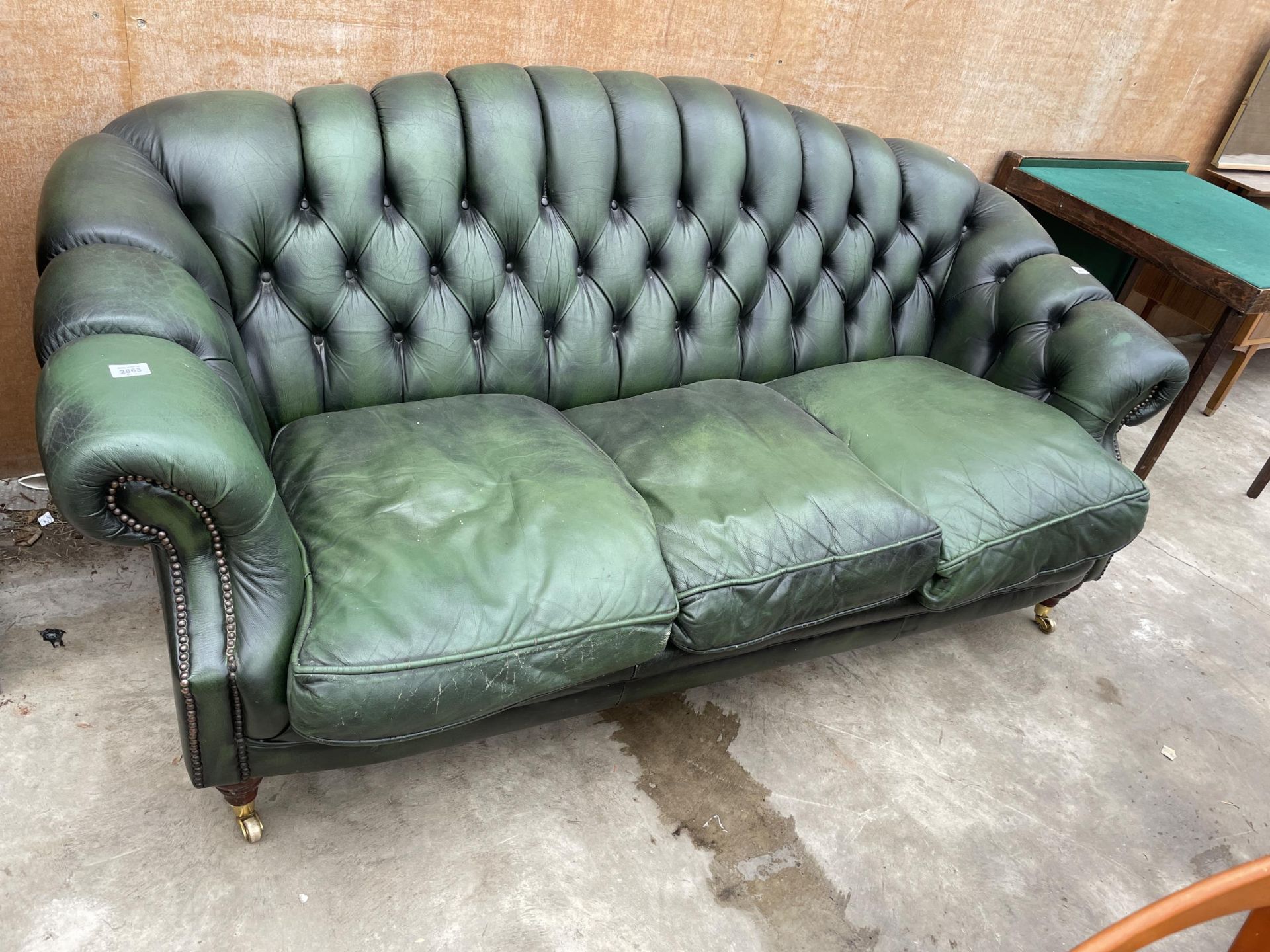 A GREEN LEATHER 'WINCHESTER FURNITURE' CHESTERFIELD THREE SEATER SETTEE