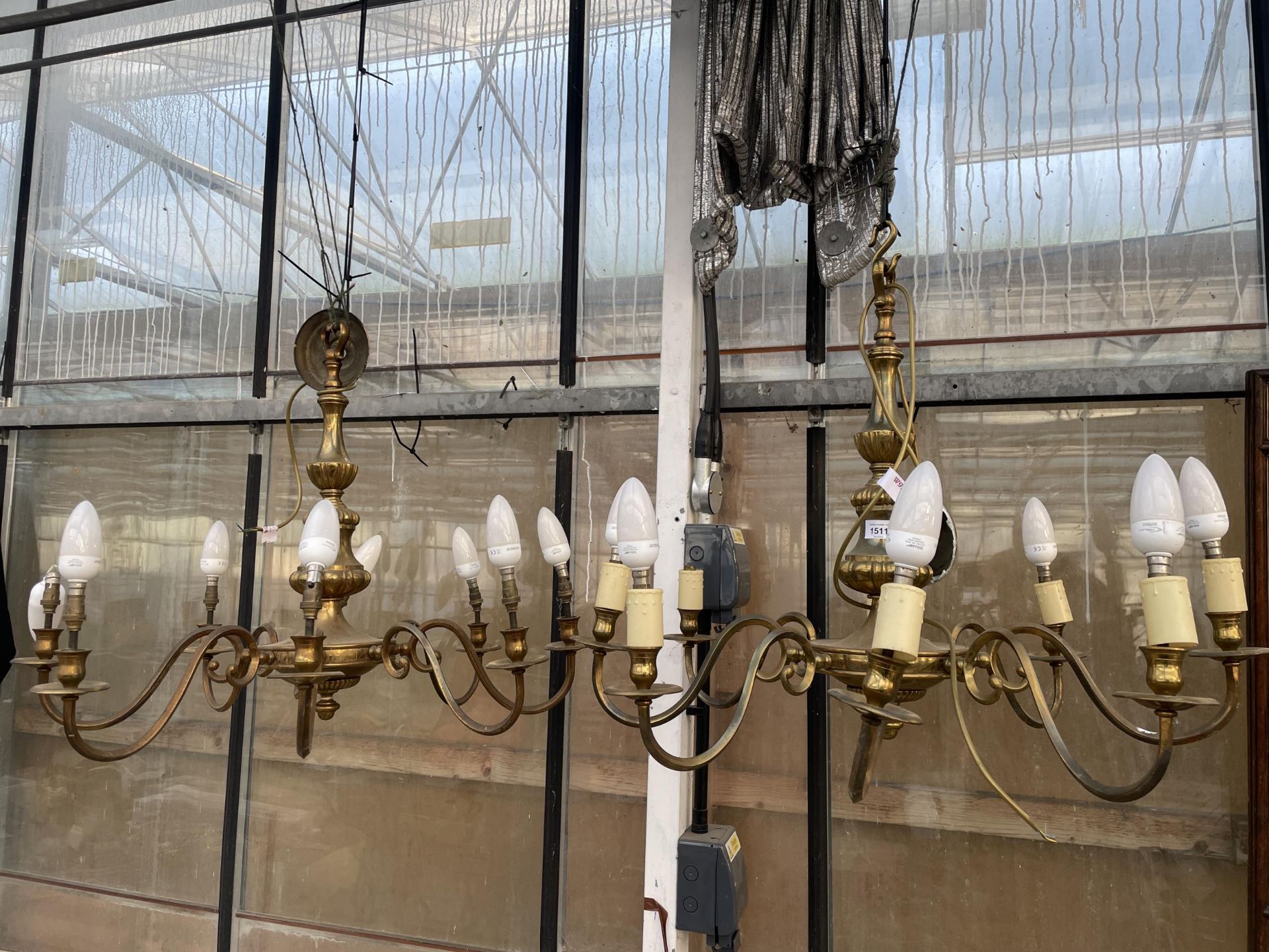 A PAIR OF EIGHT BRANCH BRASS CEILING LIGHT CHANDELIERS