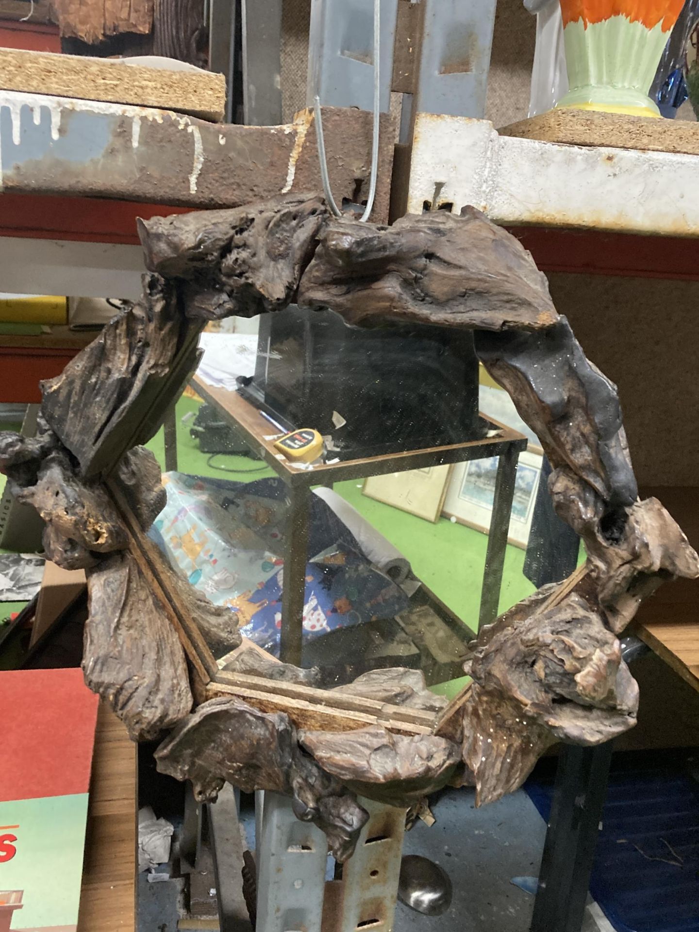 A HEXAGONAL MIRROR WITH BLACK FOREST STYLE DECORATION
