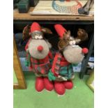 A BOY AND GIRL CHRISTMAS REINDEER FIGURES