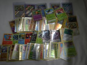 A COLLECTION OF POKEMON CARDS TO INCLUDE 100 HOLOS PLUS CARD SLEEVES