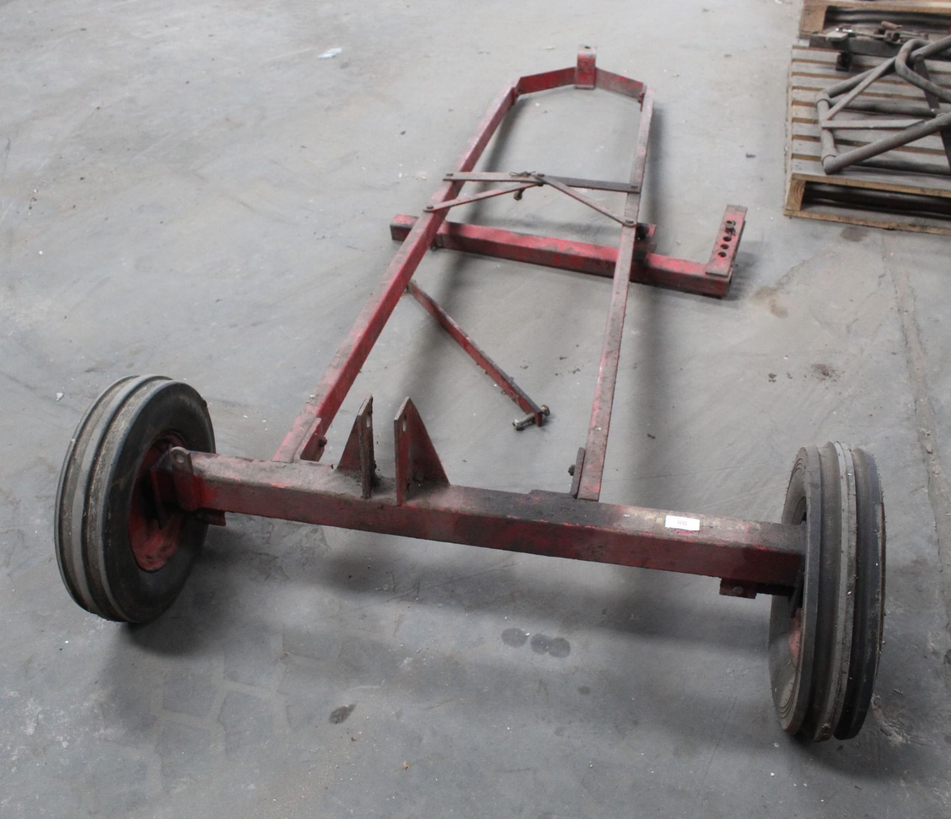 A TWO WHEELED METAL DOLLY TRAILER