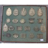 A WOODEN BOARD CONTAINING TWENTY TWO VINTAGE BRASS PLAQUES AND BADGES FROM LOCAL VINTAGE SHOWS TO