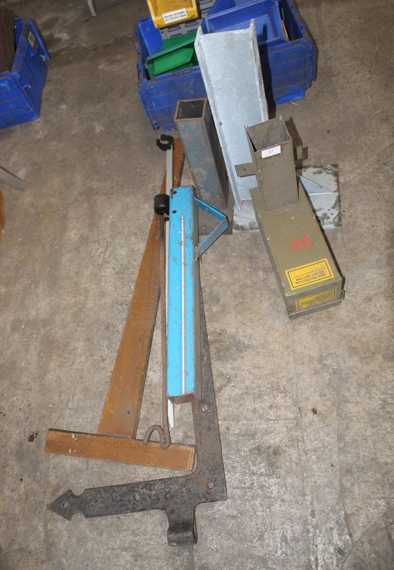 AN ASSORTMENT OF METAL BRACKETS AND A TREE POTECTION BOX ETC