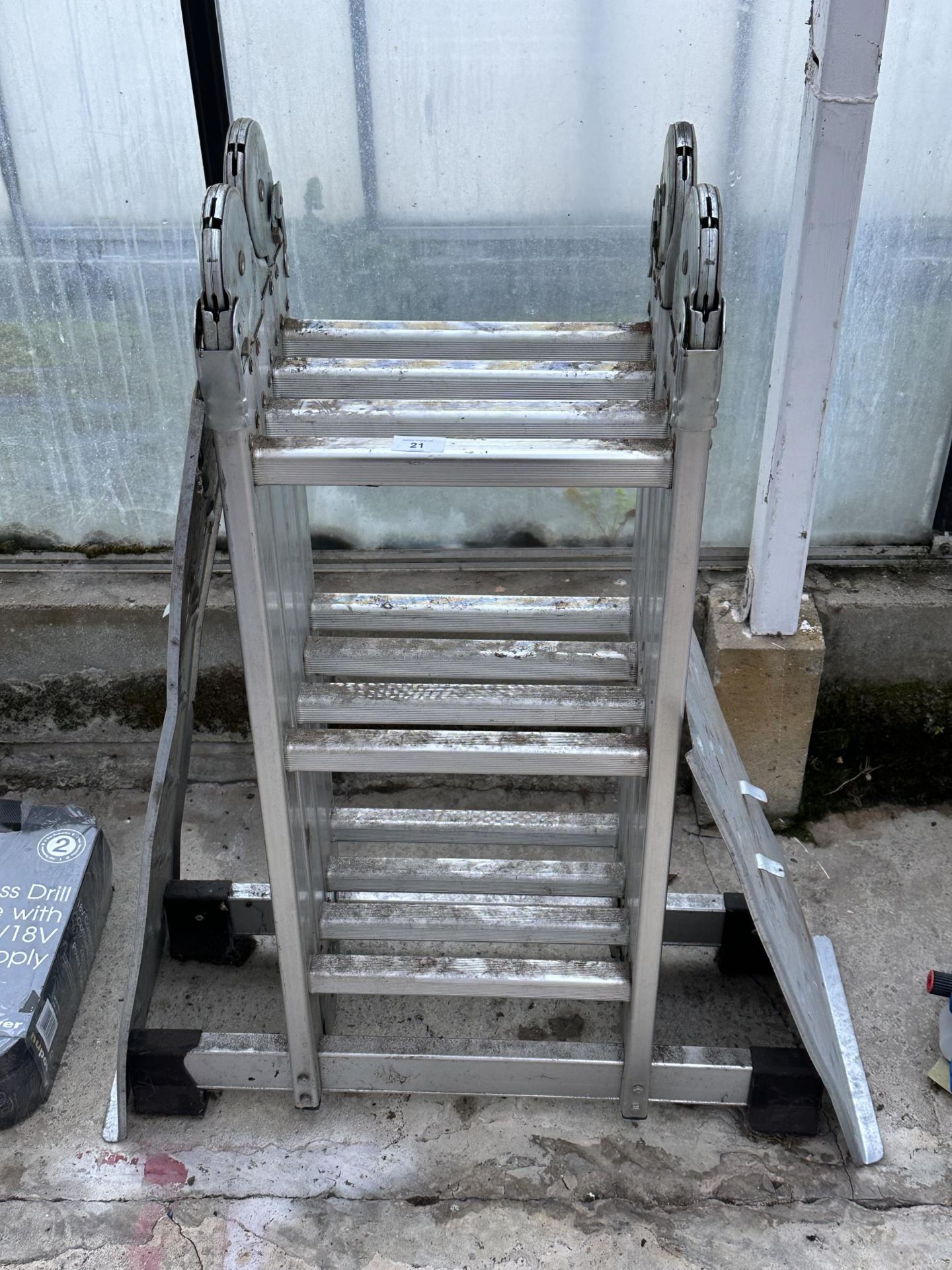 AN ALUMINIUM MULTI FUNCTIONAL FOLDING LADDER WITH DECORATORS PLATFORM NO VAT