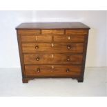 A Georgian mahogany chest of three drawers with boxwood stringing and three secret drawers, raised