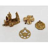 Four 9ct gold charms including a model of Truro cathedral etc. total weight 10.7g