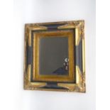 A decorative black and gilt framed mirror. Marked to the rear Carvers & Gilders, England. Overall