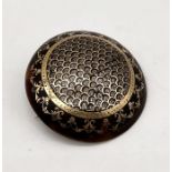 A Victorian tortoiseshell gold and silver pique inlaid bombe shield brooch