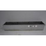 A large galvanised trough. 244cm x 49cm