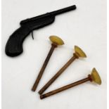 A vintage TSL dart gun and three darts