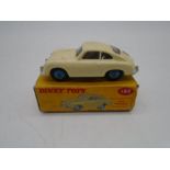 A vintage boxed Dinky Toys die-cast Porsche 356A Coupe with windows, comprising of cream body with