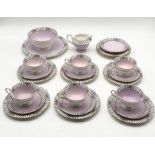 An early 20th century Shelley part tea set in Mauve with black and white flowered detail to top, set