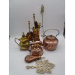 A collection of brass and copper ware including kettles, powder flask (A/F), fireside set etc.