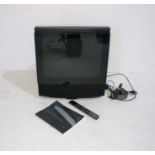 A Bang & Olufsen MX 4200 TV with remote and instruction book.