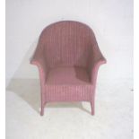 A pink Lloyd Loom chair.