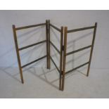 A vintage folding wooden clothes rail