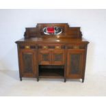 An Edwardian sideboard with carved detailing, length 155cm, height 134cm, depth 55cm.