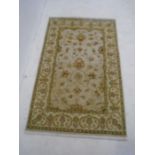 An Indian beige ground rug - Overall size 186cm x 116cm