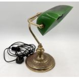 A banker's lamp with green glass shade