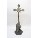 A metal cross on plinth, A/F, height 55cm.