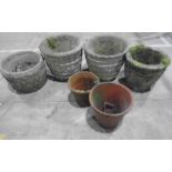 Four reconstituted stone planters including one pair plus two terracotta pots.