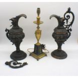 A pair of metal classical urns, one A/F, along with a brass lamp.