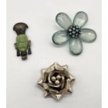 A 925 silver brooch in the form of a rose, African mask brooch and mid century flower brooch (1
