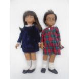 Two unboxed vintage Sasha dolls, one in tartan dress, both wearing glasses