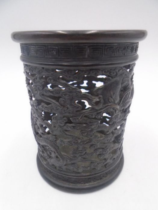 A 19th Century Oriental pierced bronze cylindrical pot decorated with three toed dragons and Greek