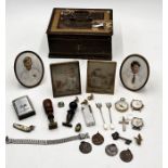 A collection of miscellaneous items including coins, portraits, watches, compass etc. in a metal