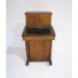 An Edwardian inlaid mahogany Davenport with cupboard under.