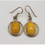 A pair of 9ct gold earrings set with butterscotch amber