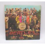 The Beatles "Sgt. Pepper's Lonely Hearts Club Band" 12" vinyl record, stereo pressing with card