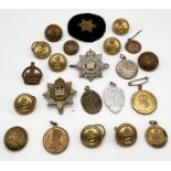A collection of military badges, buttons etc.