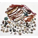 A collection of vintage costume jewellery including a number of beads, amber coloured necklaces