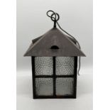 A large metal framed lantern with textured glass panels - overall height 50cm, width 34cm